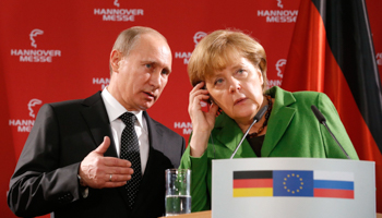Russian President Vladimir Putin translates a question from a journalist for German Chancellor Angela Merkel  (REUTERS/Fabrizio Bensch)