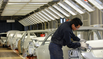 An employee works on the assembly line at a car factory in Puebla (Reuters/Imelda Medina)