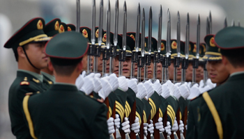 An officer ensures that members of a military guard of honour are standing in the same plane before a ceremony in Beijing (Reuters/Jason Lee)