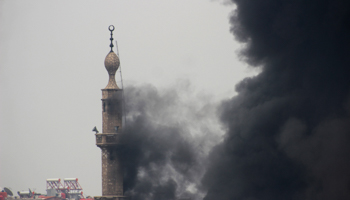 Smoke comes out from a mosque tower during fighting in Damascus (Reuters/Mohamed Dimashkia)