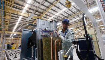 An employee works on a production line at a factory in India (Reuters/Mansi Thapliyal)