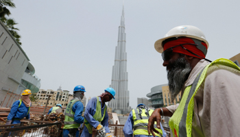 Labourers work near the Burj Khalifa (Reuters/Ahmed Jadallah)