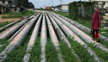 A girl walks on a gas pipeline near Port Harcourt (Reuters/Akintunde Akinleye)
