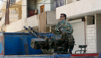 A Free Syrian Army fighter sits on a pick-up truck mounted with anti-aircraft weapon  (Reuters/Muzaffar Salman)