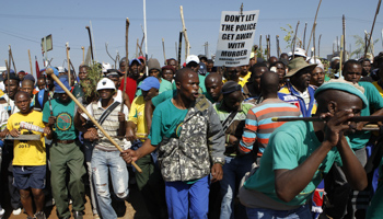 Miners march during a strike at Lonmin's Marikana platinum mine (Reuters/Siphiwe Sibeko)