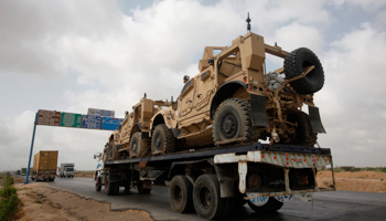 A trailer transports armoured vehicles away from Afghanistan (Reuters/Athar Hussain)