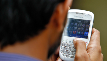 A man checks his mobile phone (Reuters/Anindito Mukherjee)