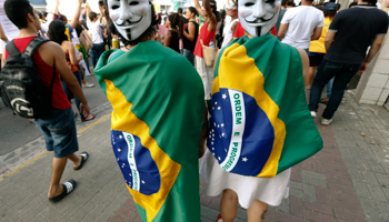 Demonstrators wearing Guy Fawkes masks attend a protest in Recife (Reuters/Marcos Brindicci)