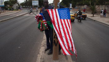 Workers attach US and Senegalese flags to lamp posts before Obama's arrival in Dakar (Reuters/Joe Penney)