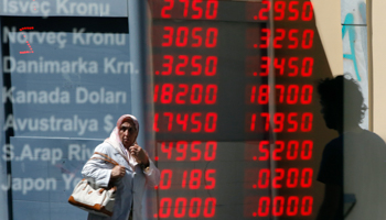 A woman walks past a currency exchange office in Istanbul (Reuters/Marko Djurica)