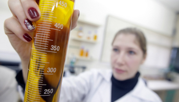 A chemical engineer holds up a test-tube of biofuel (Reuters/Bruno Domingos)