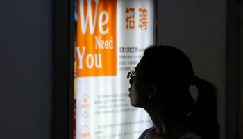 A job seeker looks at a job advertisement board at a  service centre (Reuters/Kim Kyung-Hoon)