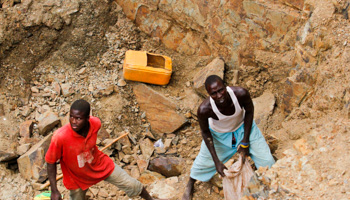 Workers pack rock samples into a bag at a mine (Reuters/Afolabi Sotunde)