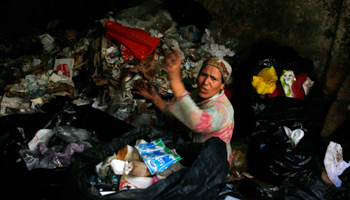 A woman looks through rubbish in a garbage dump in Cairo (Reuters/Asmaa Waguih)