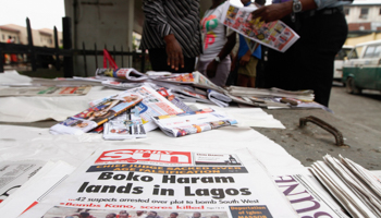 Newspapers are displayed at a vendor's stand along a road in Obalende (Reuters/Akintunde Akinleye)