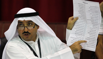 A judge counts votes at a polling station (Reuters/Hamad I Mohammed)