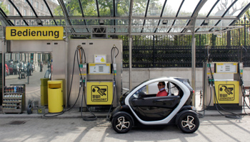 An electric car parks in front of a petrol station in Vienna (Reuters/Herwig Prammer)