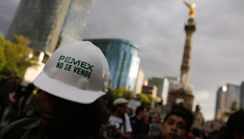 A demonstrator wears a helmet with a sticker that reads "Pemex is not for sale"  (Reuters/Tomas Bravo)