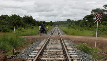 A man rides a bicycle over a railway line in Mozambique (Reuters/Agnieszka Flak)