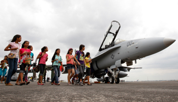 Visitors walks past a US Jet fighter on display at the formerly US, Clark Air Base (Reuters/Romeo Ranoco)