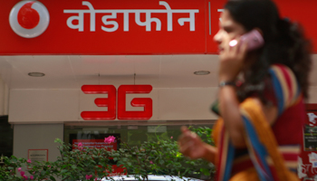 A woman walks past a Vodafone store in Mumbai (Reuters/Danish Siddiqui)