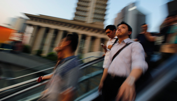 People take a escalator in Shanghai (Reuters/Carlos Barria)