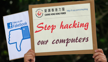 A demonstrator from the pro-China "Caring Hong Kong Power" group holds a sign (Reuters/Bobby Yip)