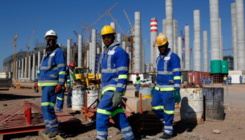 Workers are seen in front of Eskom's Medupi power station (Reuters/Siphiwe Sibeko)