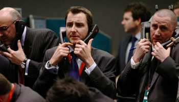 Traders and clerks react on the floor of the London Metal Exchange (Reuters/Luke MacGregor)