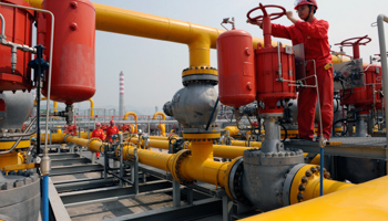 An employee checks on Sinopec natural gas transmission facilities (Reuters/Stringer)