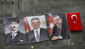 Workers hang portraits of modern Turkey's founder Mustafa Kemal Ataturk, President Abdullah Gul and Prime Minister Tayyip Erdogan (Reuters/Murad Sezer)