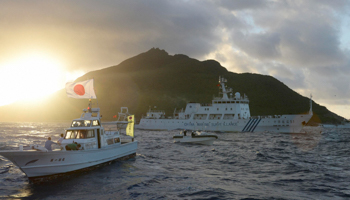 Chinese marine surveillance ship Haijian No. 51 sails near Japan Coast Guard vessels and a Japanese fishing boat (Reuters/Kyodo)