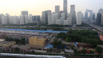 A China Railway High-speed Harmony bullet train drives past Beijing's central business district (Reuters/Jason Lee)