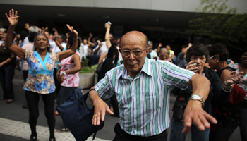 Elderly people dance on a street during the International Day of Older Persons in Sao Paulo (Reuters/Nacho Doce)