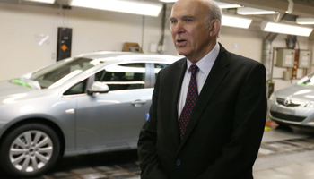 Vince Cable talks to journalists on the production line at the Vauxhall plant in Ellesmere Port (Reuters/Phil Noble)