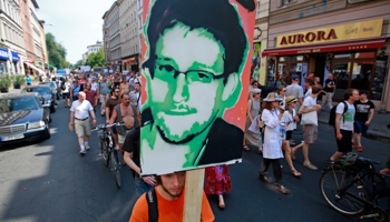 A protester carry a portrait of Edward Snowden during a demonstration against secret monitoring programmes in Berlin (Reuters/Pawel Kopczynski)