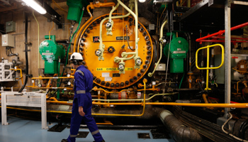 A worker walks in the turbine hall inside EDF Energy's Hinkley Point B Nuclear Power Station (Reuters/Suzanne Plunkett)