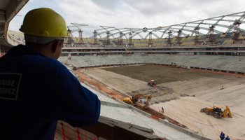 Workers plant grass inside the Arena da Amazonas Stadium in Manaus (Reuters/Bruno Kelly)