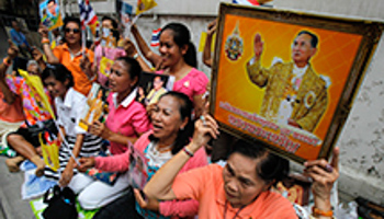 Well-wishers hold portraits of Thailand's King Bhumibol Adulyadej (Reuters/Chaiwat Subprasom)