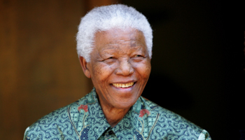Former South African President Nelson Mandela smiles (Reuters/Mike Hutchings)