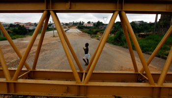 A child walks near the future site of the Angre bridge in Abidjan, Ivory Coast (Reuters/Thierry Gouegnon)