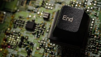 The 'End' key from a computer keyboard is placed on a plate of integrated circuit (Reuters/Kacper Pempel)