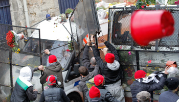 Protesters throw potted chrysanthemums at French riot police in western France (Reuters/Stephane Mahe)