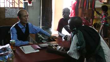 A Chinese merchant talks to customers in his shop in Salima, near the shores of Lake Malawi (Reuters/Ed Cropley)