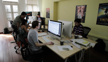 Staff members work on their computers at their office in Singapore (Reuters/Tim Chong)