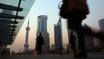 People walk along an elevated walkway at the Pudong financial district in Shanghai (Reuters/Carlos Barria)