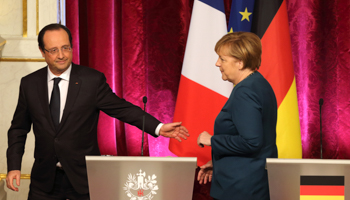 French President Francois Hollande and German Chancellor Angela Merkel leave a press conference at the Elysee Palace in Paris (Reuters/Philippe Wojazer)