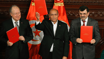 Tunisia's National Assembly President Mustapha Ben Jaafar, President Moncef Marzouki and outgoing Prime Minister Ali Larayedh pose after signing the country's new constitution (Reuters/Anis Mili)