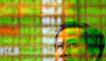 An investor monitors stock market prices in Kuala Lumpur (Reuters/Bazuki Muhammad)