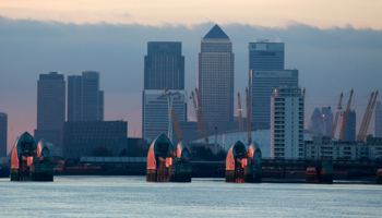 London's financial district is seen behind the Thames Barrier (Reuters/Russell Boyce)